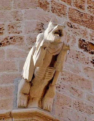 Rampant animal monster gargoyle from the Cathedral of Palma de Mallorca. It has the head of a dog and membranous wings.
